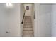 Staircase leading upwards with light wood steps and a sleek black handrail at 2925 Wigwam Pkwy # 123, Henderson, NV 89074