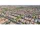 An aerial shot shows a well-organized residential area with houses, streets, and verdant landscaping, all framed by distant mountains at 2940 Duverney Ave, Henderson, NV 89044