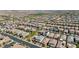 An expansive aerial view shows a Primary-planned community featuring a blend of residential homes and green spaces at 2940 Duverney Ave, Henderson, NV 89044