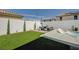 Lush backyard with artificial turf, a pool with lounge chairs, and an outdoor seating area for relaxation at 2940 Duverney Ave, Henderson, NV 89044