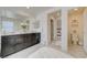 Bright bathroom featuring a double vanity, large mirror and view into bedroom and toilet room at 2940 Duverney Ave, Henderson, NV 89044