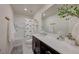 A well-lit bathroom with a spacious countertop, a decorative plant, and a shower-tub combo at 2940 Duverney Ave, Henderson, NV 89044