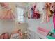 A cute walk-in closet with hanging clothes, dress, chair, and organizer drawers at 2940 Duverney Ave, Henderson, NV 89044