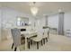 Airy dining area featuring a chic chandelier, a mirrored table, and elegant decor at 2940 Duverney Ave, Henderson, NV 89044