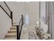 Inviting foyer with elegant decor, neutral tones, and a modern staircase leading to the upper level at 2940 Duverney Ave, Henderson, NV 89044