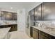 Stylish kitchen features granite countertops, stainless steel appliances, and sleek, dark wood cabinets at 2940 Duverney Ave, Henderson, NV 89044