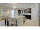 Bright kitchen boasts a spacious island with barstool seating and dark wood cabinetry at 2940 Duverney Ave, Henderson, NV 89044