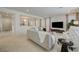 Contemporary living room with white tiled floors and a view into the entryway at 2940 Duverney Ave, Henderson, NV 89044