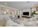 Bright living room with stylish furniture, white tile flooring, and a large-screen TV at 2940 Duverney Ave, Henderson, NV 89044