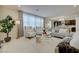 Bright living area featuring large windows, stylish seating, and a seamlessly connected open floorplan at 2940 Duverney Ave, Henderson, NV 89044