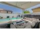 Inviting covered patio with comfortable seating, stylish decor, and a view of the sparkling pool and waterfall feature at 2940 Duverney Ave, Henderson, NV 89044