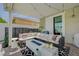 Relaxing covered patio with sectional seating, stylish decor, and cozy fire pit for outdoor entertaining at 2940 Duverney Ave, Henderson, NV 89044