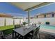 Covered patio with outdoor dining, lush artificial turf, and sparkling pool with relaxing lounge chairs at 2940 Duverney Ave, Henderson, NV 89044