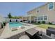 Inviting backyard features a sparkling pool, lounge chairs, and covered patio with outdoor seating at 2940 Duverney Ave, Henderson, NV 89044