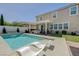 Expansive backyard featuring a serene pool, covered patio, and lush landscaping perfect for relaxing at 2940 Duverney Ave, Henderson, NV 89044