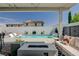 Relaxing backyard oasis with a refreshing pool, waterfall feature, cozy seating, and modern fire pit at 2940 Duverney Ave, Henderson, NV 89044