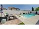 Backyard view features a refreshing pool, modern lounge chairs, and comfortable patio seating for outdoor relaxation at 2940 Duverney Ave, Henderson, NV 89044