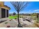 Relaxing back patio with beautiful golf course views and stylish stone flooring at 33 Hassayampa Trl, Henderson, NV 89052