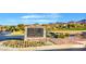 Community entrance sign with directions to the clubhouse, golf shop, and other amenities at 33 Hassayampa Trl, Henderson, NV 89052