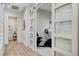 Hallway with modern doors and hardwood floors leading to a gym and a bathroom at 33 Hassayampa Trl, Henderson, NV 89052