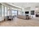 Spacious living room featuring tile floors, a modern fireplace, and access to an outdoor patio at 33 Hassayampa Trl, Henderson, NV 89052