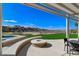 Outdoor patio area with a fire pit, spa and manicured backyard at 33 Hassayampa Trl, Henderson, NV 89052