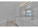 Bathroom with dual sinks, soaking tub, and neutral color palette at 3544 Mountain Valley Dr, Las Vegas, NV 89129