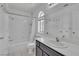 Bathroom with a shower/tub combo, dark wood vanity, and a arched window at 3544 Mountain Valley Dr, Las Vegas, NV 89129