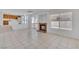 Open-concept living space with fireplace, tile flooring, and view into the kitchen at 3544 Mountain Valley Dr, Las Vegas, NV 89129