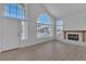 Bright living room featuring a fireplace, large windows, and modern flooring at 3544 Mountain Valley Dr, Las Vegas, NV 89129