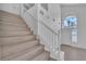 Elegant staircase showcasing wood steps and a bright entry with a decorative window at 3544 Mountain Valley Dr, Las Vegas, NV 89129