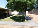Spacious backyard with healthy lawn, mature shade trees, decorative rock and a comfortable covered patio at 391 Newbury Ct, Henderson, NV 89015