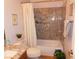 Bathroom featuring granite countertops, tile details, and a shower-tub combo at 391 Newbury Ct, Henderson, NV 89015