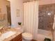 Bathroom featuring granite countertops, tile details, and a shower-tub combo at 391 Newbury Ct, Henderson, NV 89015