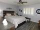 Stylish bedroom with hardwood-look floors, ceiling fan, and large window at 391 Newbury Ct, Henderson, NV 89015
