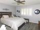 This bedroom features wood-look floors, a ceiling fan, and an accent wall decoration at 391 Newbury Ct, Henderson, NV 89015