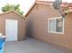 Home exterior with a shed, stucco siding, and well-maintained concrete walkway at 391 Newbury Ct, Henderson, NV 89015