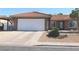 Front exterior of a single-story home with desert landscaping, featuring a two-car garage at 391 Newbury Ct, Henderson, NV 89015