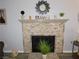 Elegant fireplace with a stone surround and decorated mantel at 391 Newbury Ct, Henderson, NV 89015