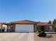 Charming single-story home features a two-car garage, desert landscaping, and a red tile roof at 391 Newbury Ct, Henderson, NV 89015