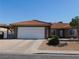 Charming home with a two-car garage and low-maintenance front yard and red tile roof at 391 Newbury Ct, Henderson, NV 89015