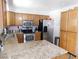 Bright kitchen featuring stainless steel appliances, granite countertops, and wooden cabinets at 391 Newbury Ct, Henderson, NV 89015