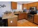 Cozy kitchen with granite countertops, stainless steel appliances, and wood-look tile flooring at 391 Newbury Ct, Henderson, NV 89015