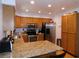 Bright kitchen featuring stainless steel appliances, granite countertops, and wood cabinets at 391 Newbury Ct, Henderson, NV 89015