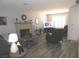 Cozy living room featuring a decorative stone fireplace and stylish, neutral décor at 391 Newbury Ct, Henderson, NV 89015