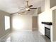 Bright living room with a fireplace, ceiling fan, and lots of natural light at 4021 Broadriver Dr, Las Vegas, NV 89108