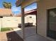 Back patio featuring tan stucco, landscaping and partial pergola with a view to an adjacent home at 4021 Broadriver Dr, Las Vegas, NV 89108