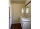 Bathroom features a large mirror, single sink vanity, lighting fixture, and wood look flooring at 416 Richgold St, Henderson, NV 89012