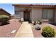 Inviting home entrance with a covered porch, desert landscaping, and a paved walkway at 416 Richgold St, Henderson, NV 89012