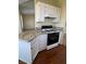 Kitchen with granite countertops, white cabinets, and gas range cooktop at 416 Richgold St, Henderson, NV 89012